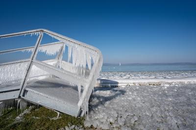 Beautiful frozen Lake Balaton with steel steps-stock-photo