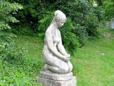 Stone statue in Botanic Garden -Woman with flower-stock-photo