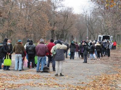 Homeless people waiting for food distribution in Népliget - Budapest-stock-photo