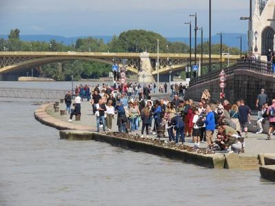 Flooded Danube river - Tourists - Budapest - Shoes Memorial-stock-photo