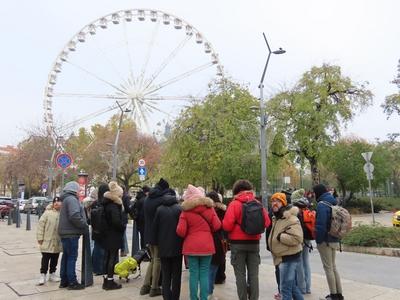 Foreign tourists in the city center under the Ferris wheel - Budapest-stock-photo